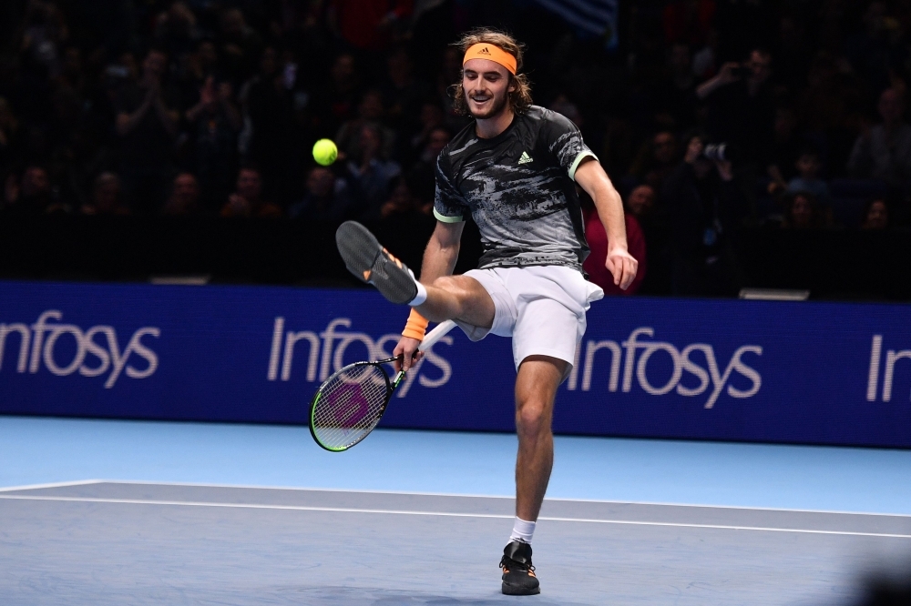Greece's Stefanos Tsitsipas celebrates victory against Switzerland's Roger Federer during the men's singles semi-final match on day seven of the ATP World Tour Finals tennis tournament at the O2 Arena in London on Saturday. — AFP