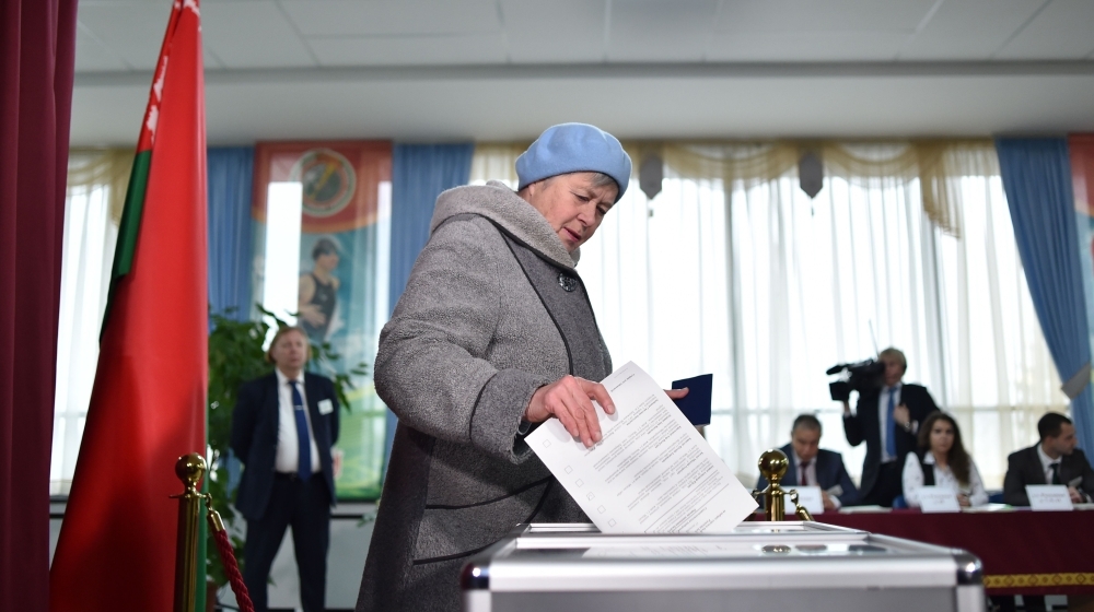 Belarus's President Alexander Lukashenko speaks with journalists as he votes at a polling station during Belarus' parliamentary election in Minsk on Sunday. -AFP