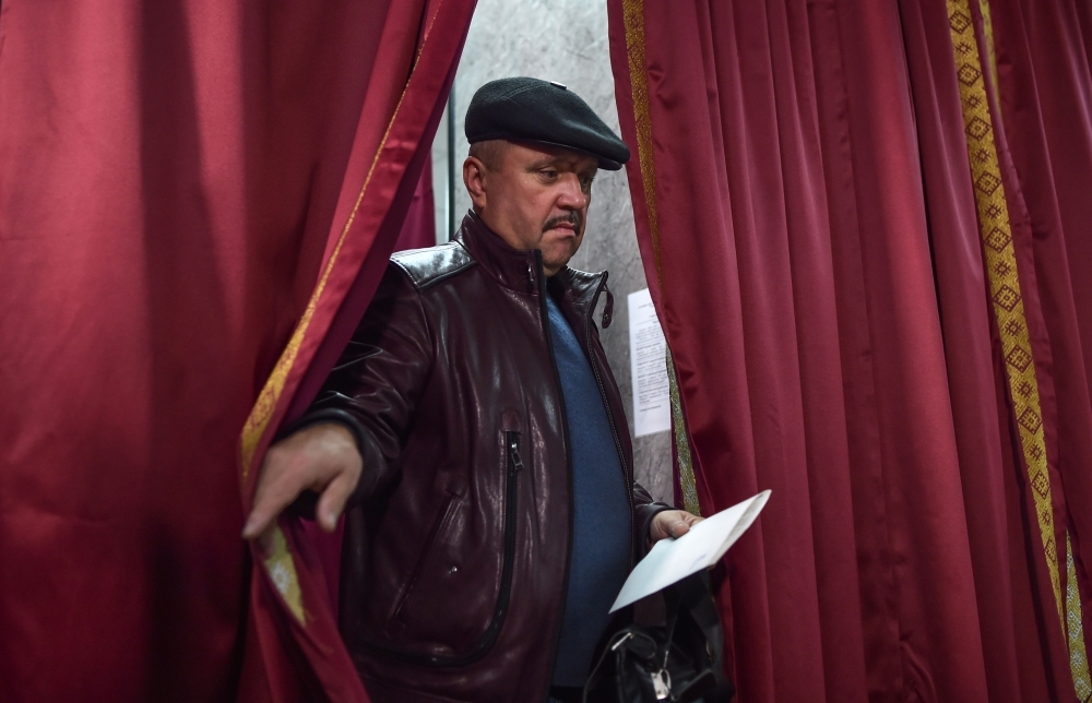 Belarus's President Alexander Lukashenko speaks with journalists as he votes at a polling station during Belarus' parliamentary election in Minsk on Sunday. -AFP