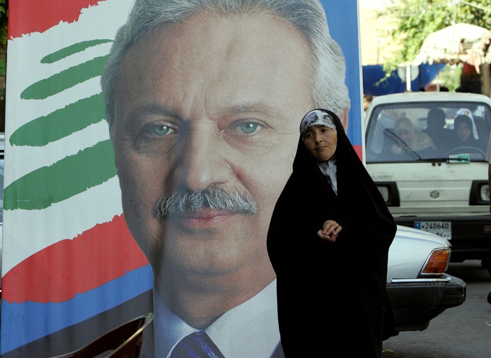 In this file photo taken on June 7, 2009, a woman walks past an election campaign poster of then economy and trade minister Mohammed Safadi in the northern Lebanese city of Tripoli. — AFP