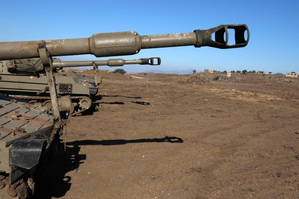 Israeli soldiers and armored vehicles are pictured on Tuesday near the border with Syria in the annexed Golan Heights. -AFP