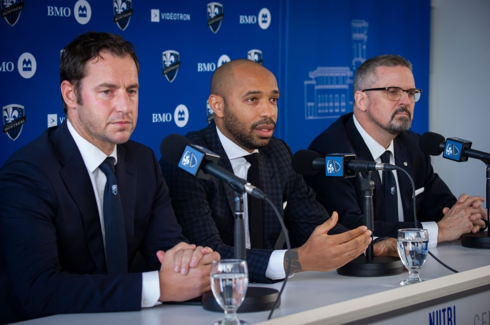 (L-R) Olivier Renard, Sporting Director,Thierry Henry, and Kevin Gilmore, President & Chief Executive Officer speak as The Montreal Impact invites members of the media to meet Thierry Henry, the new head coach at a press conference at the Center Nutrilait, in Montreal, Quebec, Canada, on Monday. — AFP