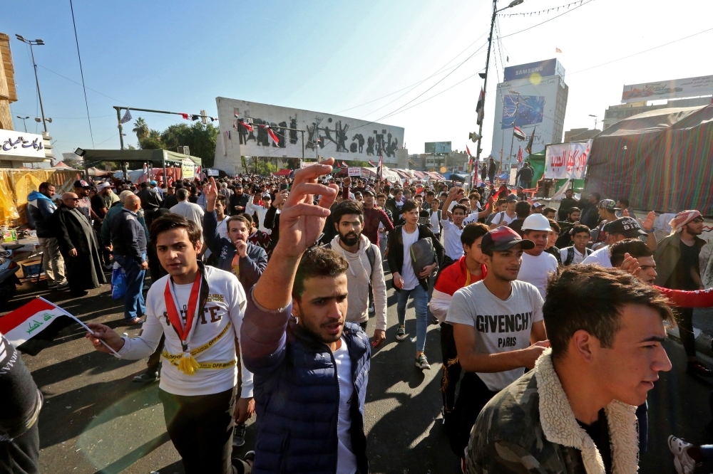 Iraqi anti-government protesters are pictured at Tahrir square on Tuesday. — AFP