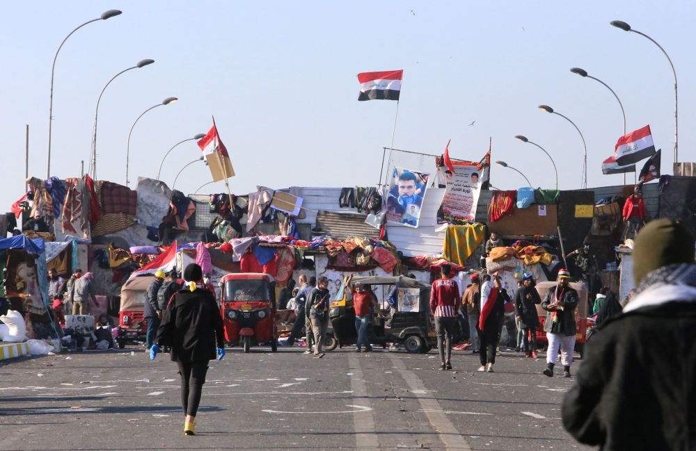 Iraqi anti-government protesters are pictured at Tahrir square on Tuesday. — AFP