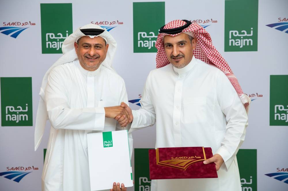 Najm’s Chairman Dr. Mohammad Al Suliman (right) and Saaed’s Chairman Eng. Ibrahim Yousef Ramel shake hands after the signing of agreement.