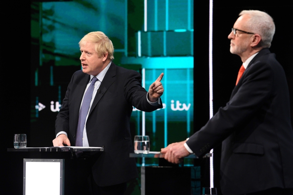 Britain's Prime Minister Boris Johnson (L) and Britain's Labour Party leader Jeremy Corbyn (R) debate on the set of 