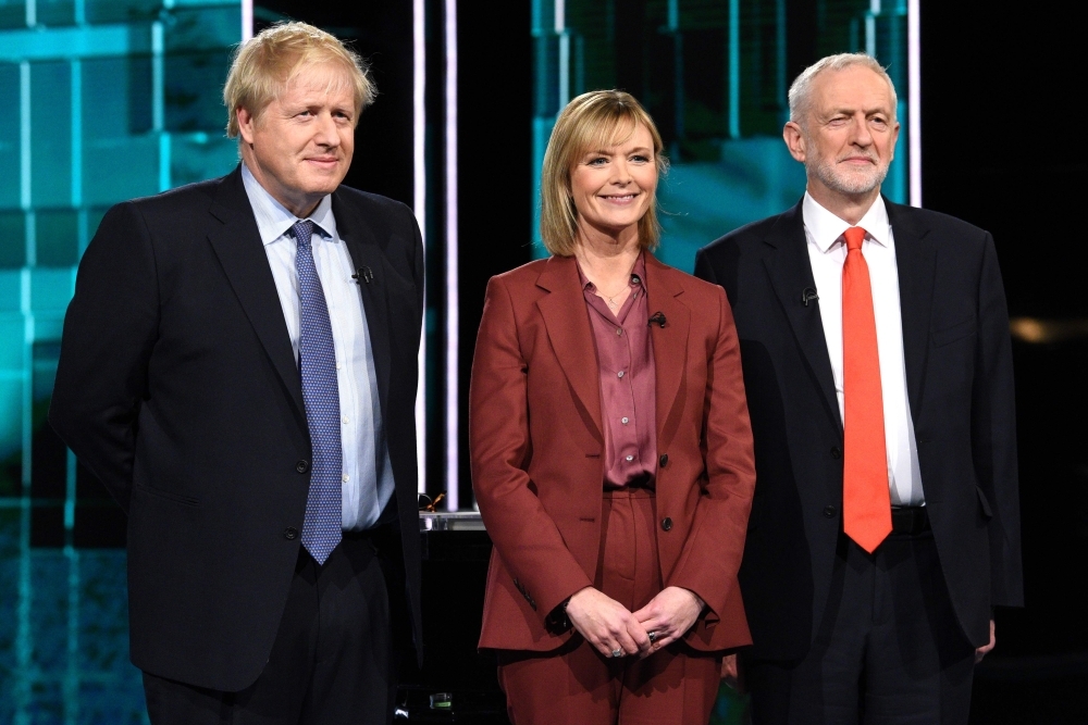 Britain's Prime Minister Boris Johnson (L) and Britain's Labour Party leader Jeremy Corbyn (R) debate on the set of 