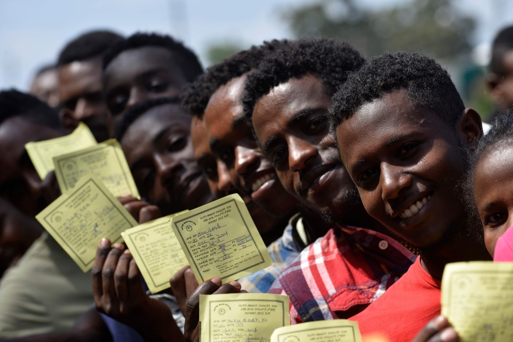 Voters pose for a picture with their identity documents while waiting in a queue to cast their vote during the Sidama referendum in Hawassa, Ethiopia, on Wednesday. — AFP