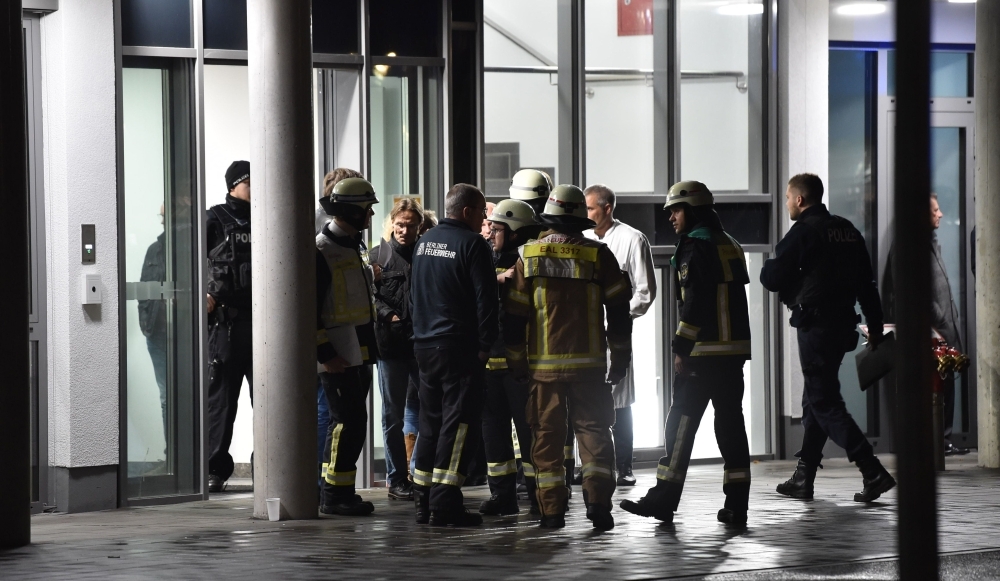 Policemen, firefighters and medical staff stand in front of the hospital after a doctor was stabbed to death as he delivered a lecture at the Schlosspark hospital in the western Berlin neighborhood of Charlottenburg, on Tuesday. — AFP