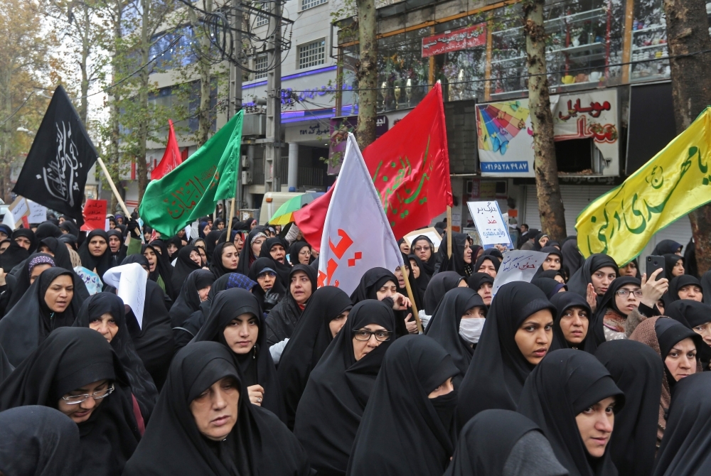 Iranian mourners attend the funeral of Morteza Ebrahimi, a commander of the Islamic Revolutionary Guard Corps, who was killed in violent demonstrations that erupted across Iran last week against a surprise petrol price hike, in the central Iranian city of Shahriar, on Wednesday. — AFP