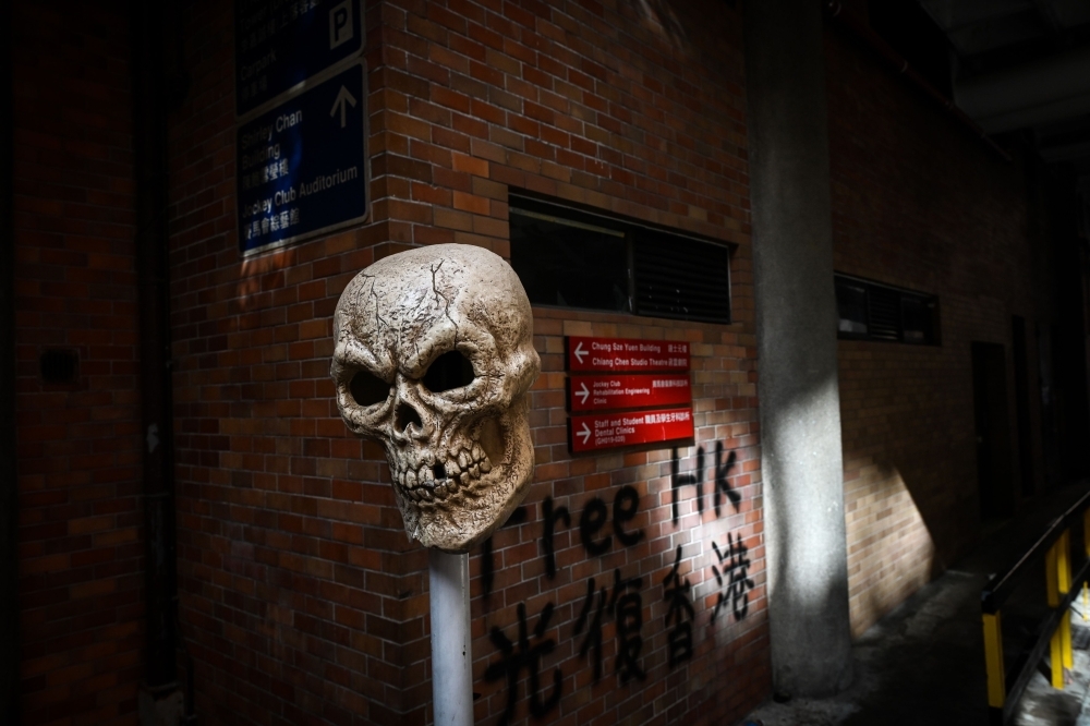 A barricade is seen at the campus of the Hong Kong Polytechnic University where dozens of pro-democracy protesters remain holed up inside, in the Hung Hom district of Hong Kong, on Thursday. — AFP