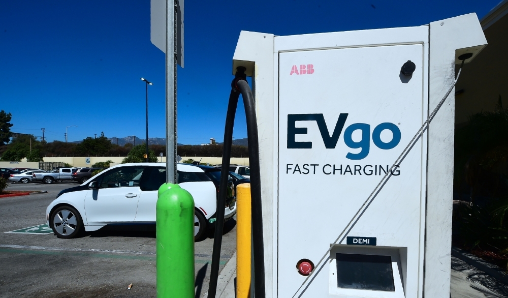 In this file photo taken on Sept. 14, 2018 An Electric Vehicle is plugged in for a charge from EV charging stations at a Walmart parking lot in Duarte, California. The rise of electric cars is proving a challenge not only for auto makers but also gas stations, supermarkets and malls forced to adapt as more and more electric vehicles hit the road, experts say. — AFP