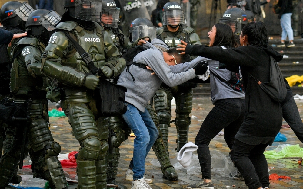 A demonstrator shouts at riot police during a nationwide strike called by students, unions and indigenous groups to protest against the government of Colombia's President Ivan Duque, in Bogota, on Thursday. — AFP