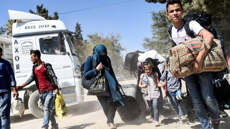 Syrian refugees walk on their way back to the Syrian city of Jarabulus at Karkamis crossing gate, in the southern region of Kilis, Turkey, in this on Sept. 7, 2016 file photo. — AFP