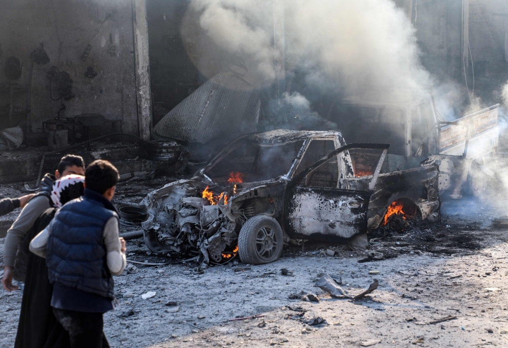 This picture taken on Saturday shows the aftermath of a car bomb explosion at the industrial zone in the northern Syrian town of Tal Abyad, on the border with Turkey. -AFP