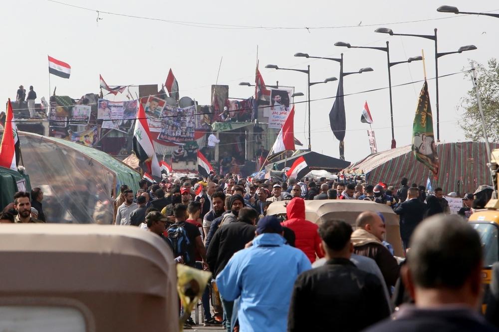 Smoke billows from burning tires during a demonstration in the southern city of Basra on Sunday, as protesters cut-off roads and activists call for a general strike. -AFP