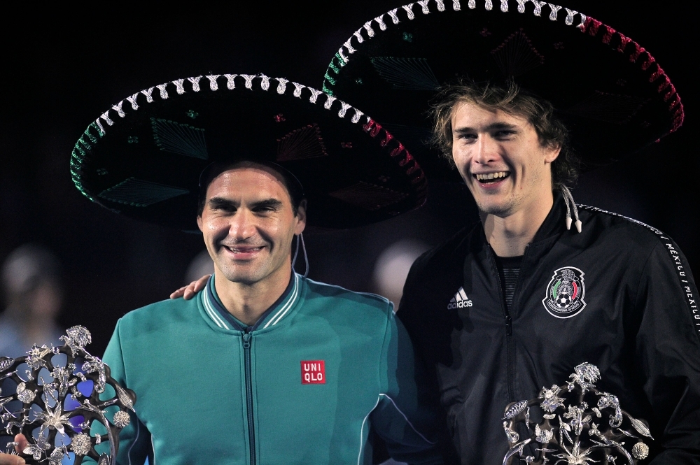 Switzerland's Roger Federer (L) and Germany's Alexander Zverev pose for pictures with Mexican hats after the exhibition tennis singles match in Mexico City, on Saturday. — AFP