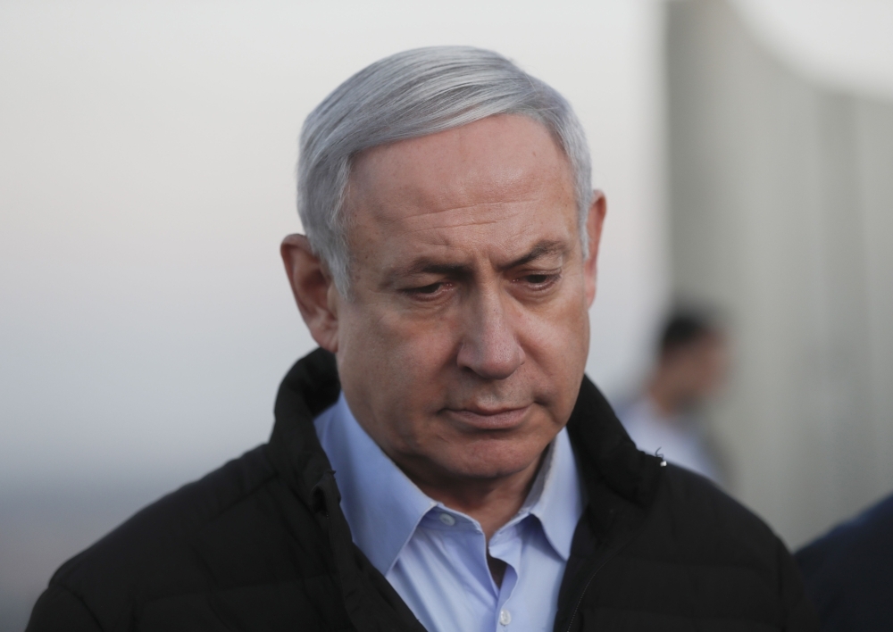 Israel's Prime Minister Benjamin Netanyahu looks on during a visit to an army base in the Israeli-annexed Golan Heights overlooking Syrian territory on Sunday. — AFP