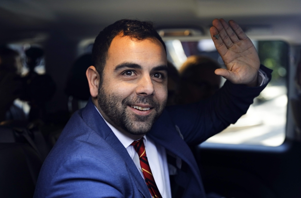US citizen Omar Shakir, the New York-based rights group Human Rights Watch (HRW) director for Israel and the Palestinian territories, waves from a car in Jerusalem on Monday. — AFP