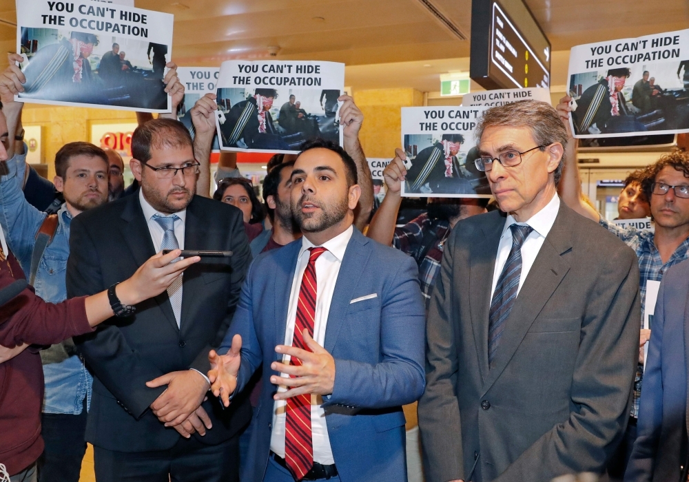 American citizen Omar Shakir, center, the director of the New York-based Human Rights Watch for Israel and the Palestinian territories, delivers a speech at Ben Gurion airport on Monday, after being expelled from Israel. — AFP