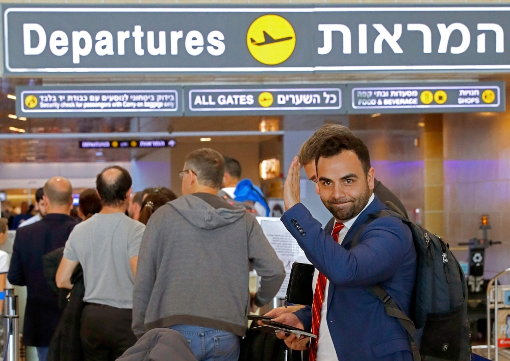 American citizen Omar Shakir, center, the director of the New York-based Human Rights Watch for Israel and the Palestinian territories, delivers a speech at Ben Gurion airport on Monday, after being expelled from Israel. — AFP