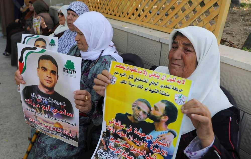 Relatives of Palestinian prisoner Sami Abu Diyak mourn at his house in Saylat Al-Dahr town, south of Jenin city in the West Bank, on Tuesday, after news of his death of cancer in an Israeli jail. — AFP