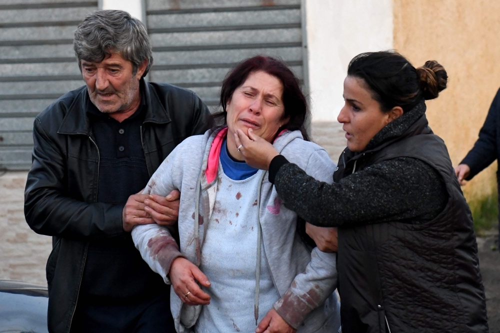 Emergency workers clear debris at a damaged building in Thumane, 34 km (about 20 miles) northwest of capital Tirana, after an earthquake hit Albania, on Tuesday. — AFP