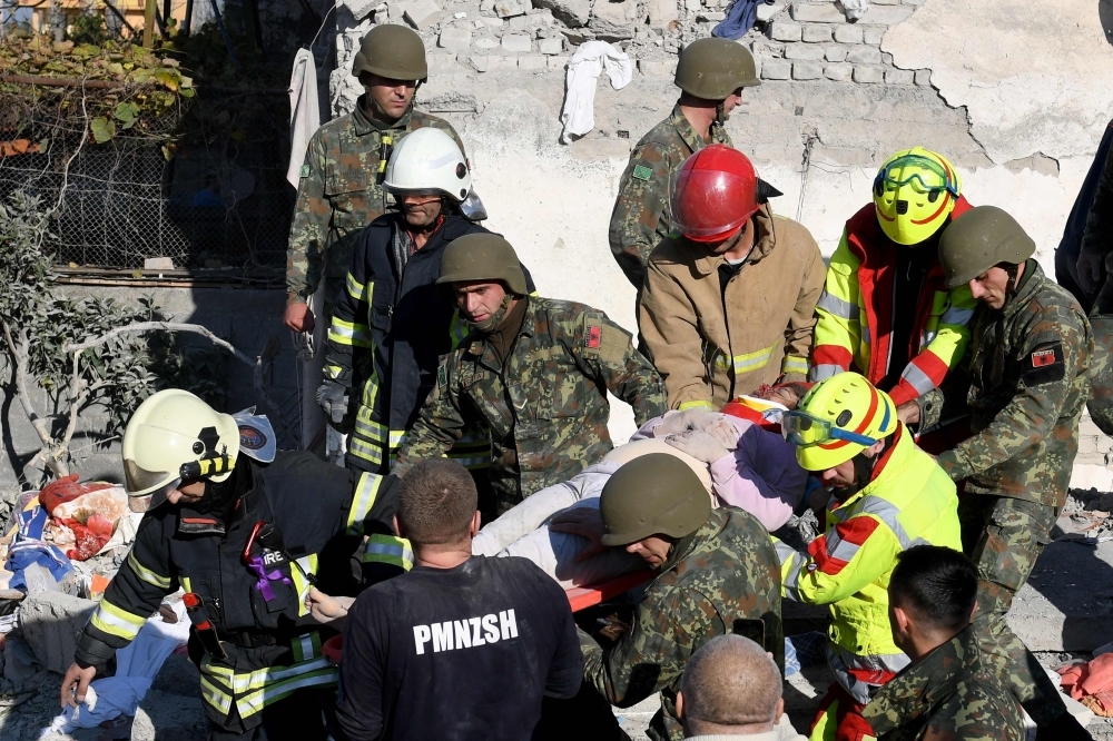 Emergency workers clear debris at a damaged building in Thumane, 34 km (about 20 miles) northwest of capital Tirana, after an earthquake hit Albania, on Tuesday. — AFP