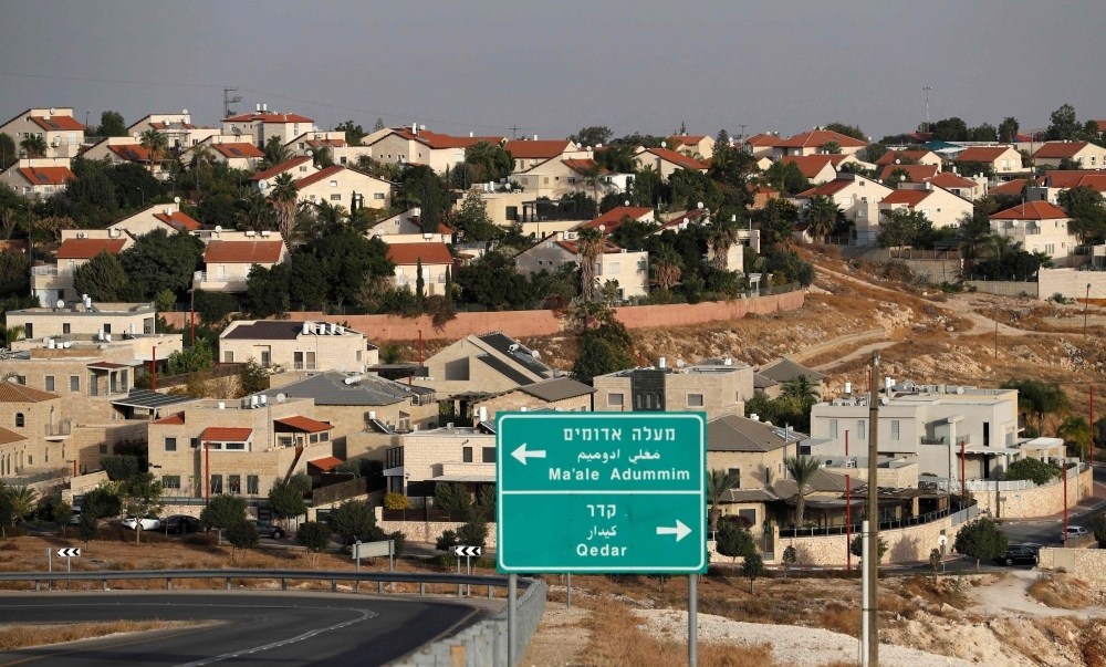 A Palestinian protester holds up a placard in the West Bank city of Ramallah on Tuesday as Palestinians stage a 