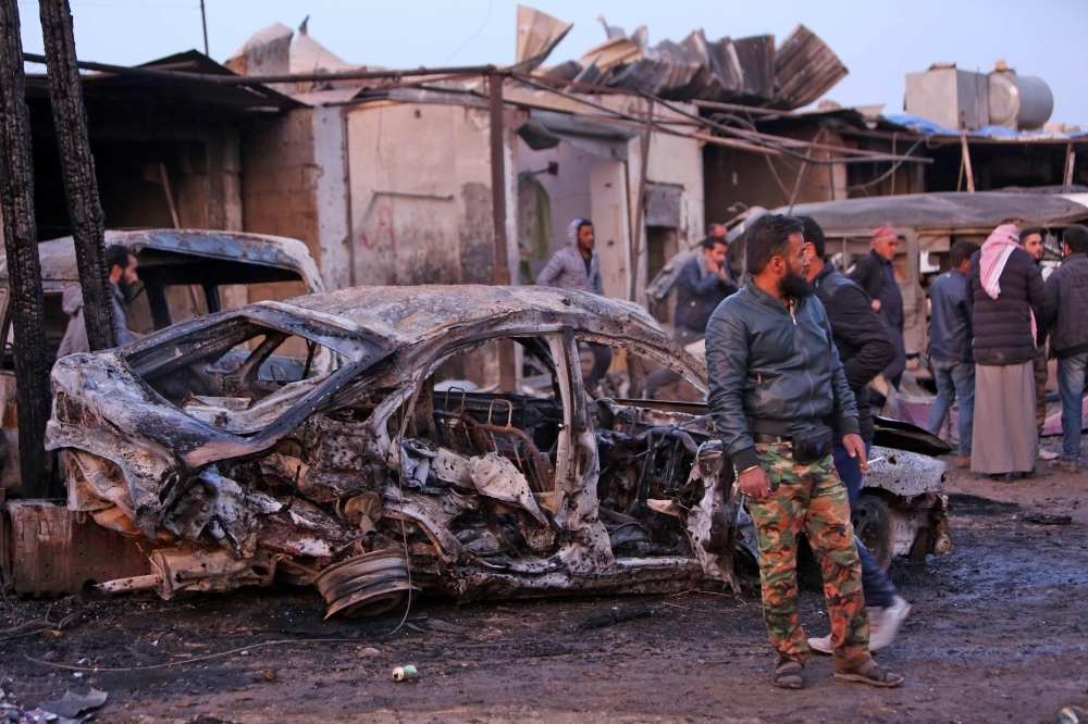 Destroyed vehicles following a car bomb attack are seen at a local market in the Turkish-held Syrian Kurdish town of Tel Hal along the border with Turkey in the northeastern Hassakeh province on Tuesday. — AFP