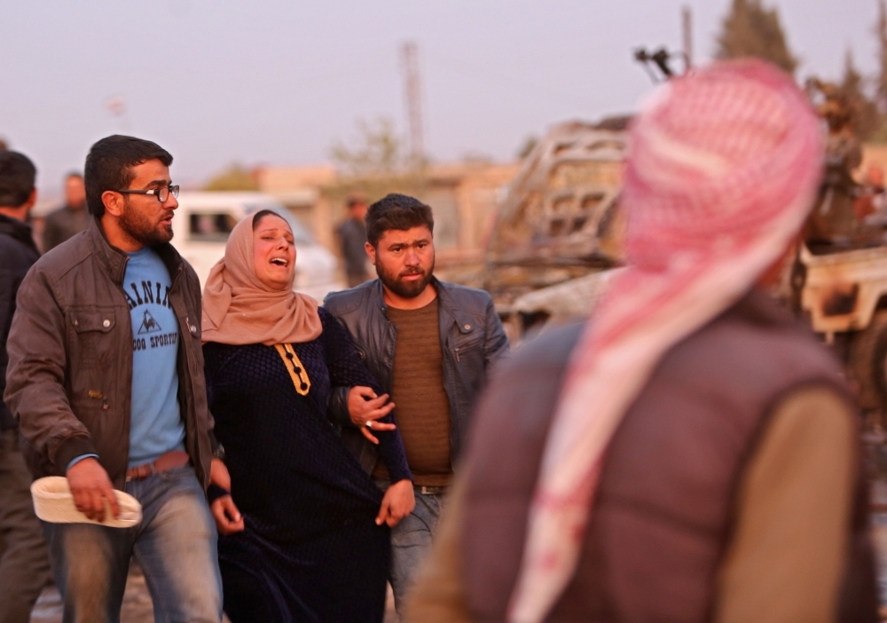 Destroyed vehicles following a car bomb attack are seen at a local market in the Turkish-held Syrian Kurdish town of Tel Hal along the border with Turkey in the northeastern Hassakeh province on Tuesday. — AFP