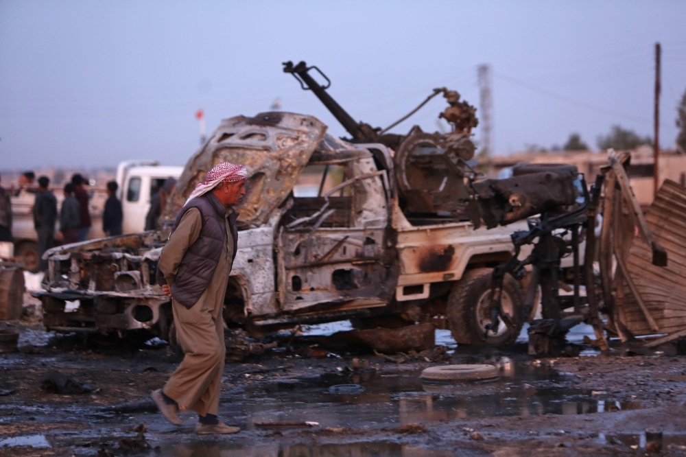 Destroyed vehicles following a car bomb attack are seen at a local market in the Turkish-held Syrian Kurdish town of Tel Hal along the border with Turkey in the northeastern Hassakeh province on Tuesday. — AFP