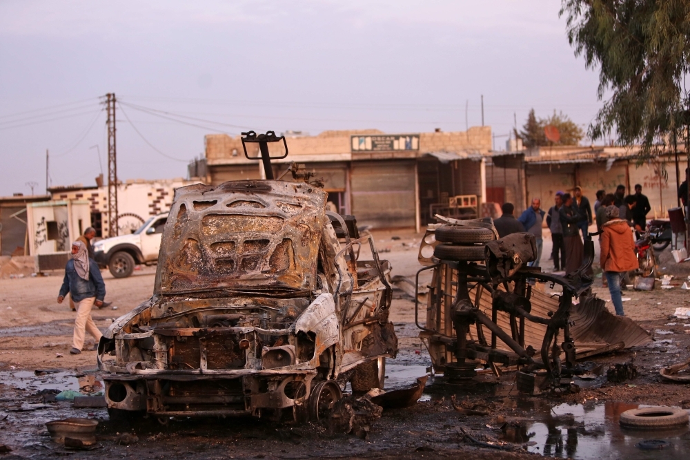 Destroyed vehicles following a car bomb attack are seen at a local market in the Turkish-held Syrian Kurdish town of Tel Hal along the border with Turkey in the northeastern Hassakeh province on Tuesday. — AFP