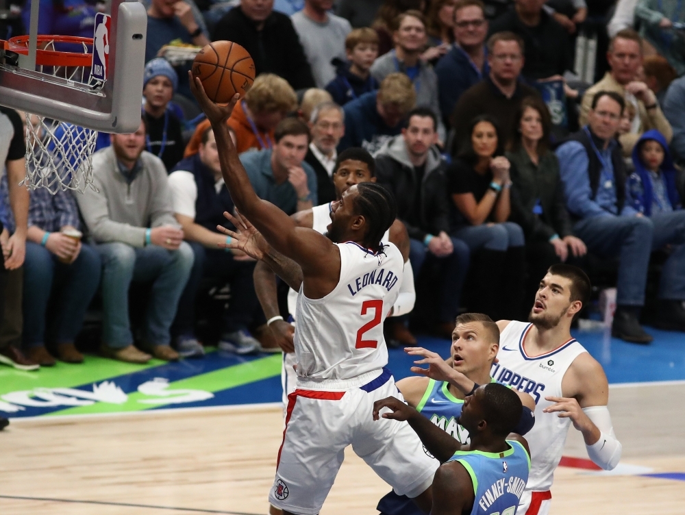 Kawhi Leonard (2) of the Los Angeles Clippers takes a shot against Kristaps Porzingis (6) and Dorian Finney-Smith (10) of the Dallas Mavericks at American Airlines Center in Dallas, Texas, on Tuesday. — AFP