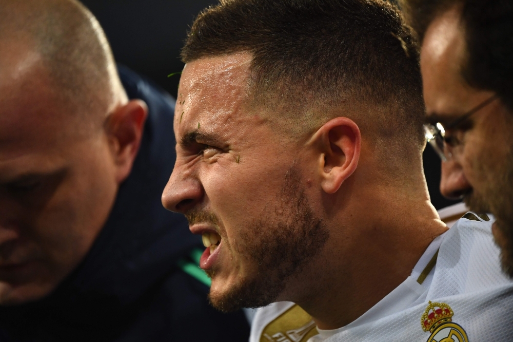 Real Madrid's Belgian forward Eden Hazard gestures in pain during the UEFA Champions League group A football match Real Madrid against Paris Saint-Germain FC at the Santiago Bernabeu stadium in Madrid, on Tuesday. — AFP