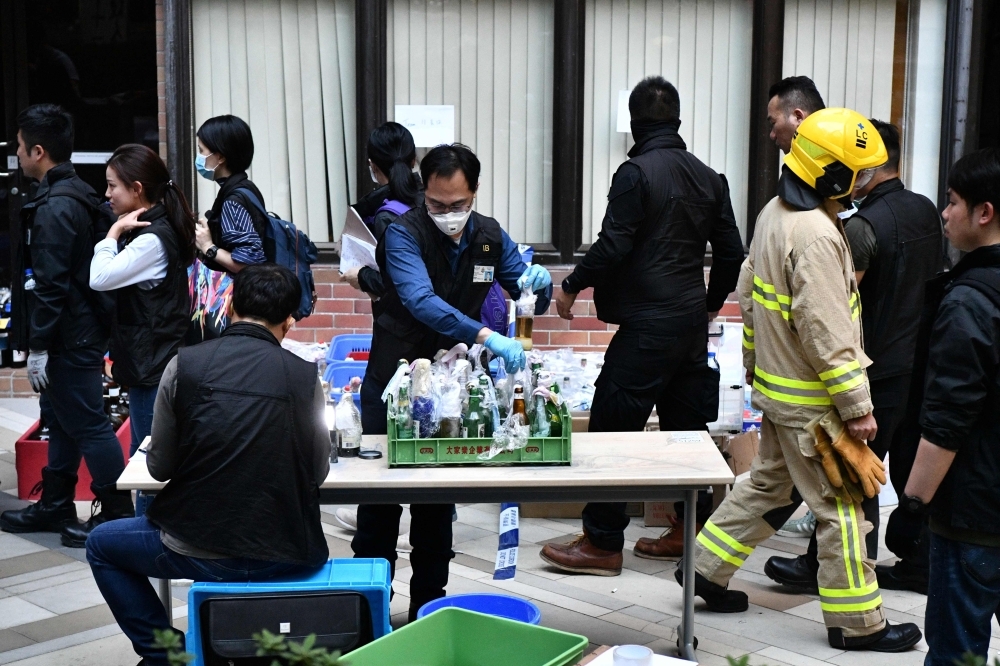 Police walk on the campus of the Hong Kong Polytechnic University in the Hung Hom district of Hong Kong on Thursday, over a week after police surrounded the building while pro-democracy protesters were still barricaded inside. — AFP