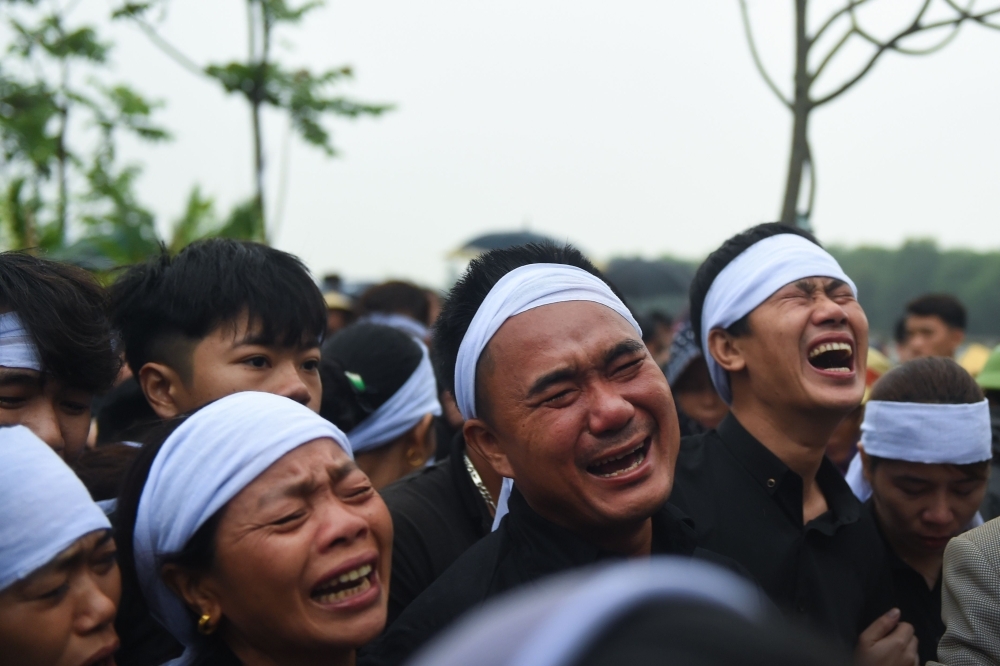 A family members of Nguyen Van Hung cry during burial of his remains at a cemetery in Dien Chau district, Nghe An province, Vietnam, on Thursday. — AFP