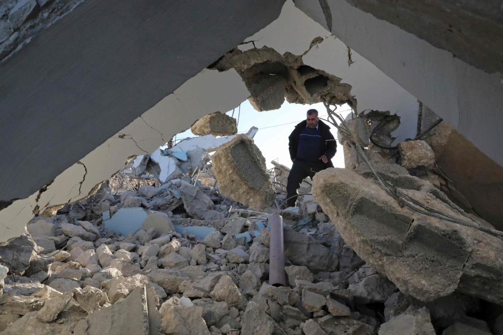Palestinians check the house of a man who reportedly carried out an attack against Israelis in August, after it was demolished by Israeli authorities in the village of Beit Kahel near the West Bank town of Hebron, on Thursday. — AFP