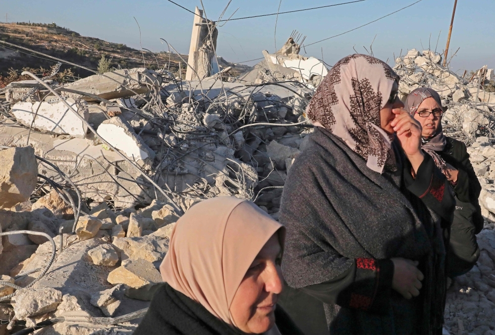 Palestinians check the house of a man who reportedly carried out an attack against Israelis in August, after it was demolished by Israeli authorities in the village of Beit Kahel near the West Bank town of Hebron, on Thursday. — AFP