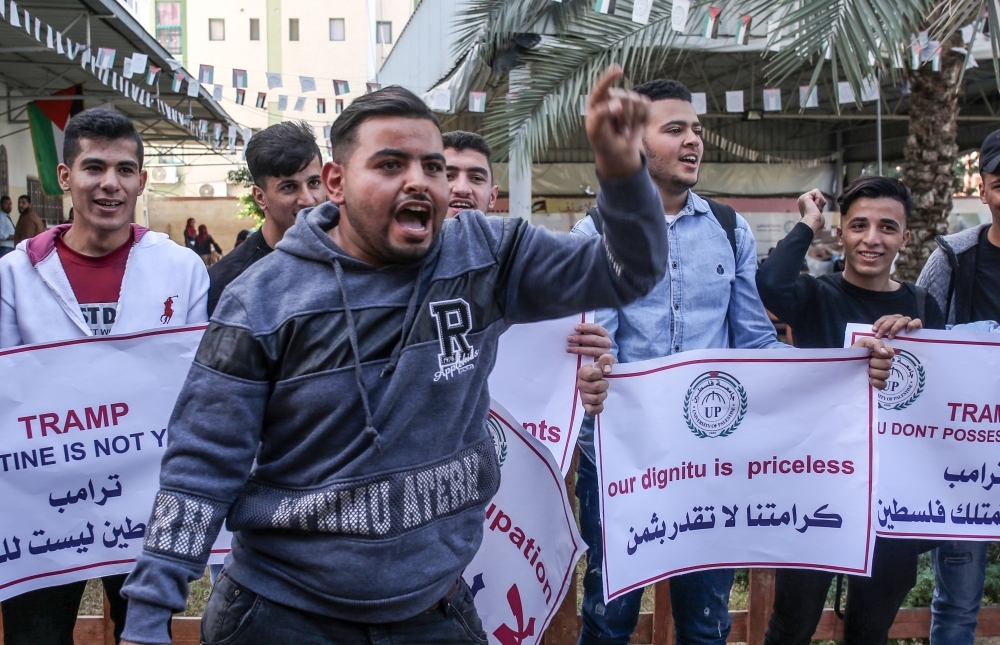 Students and professors of the University of Palestine carry placards during a demonstration against the US policy shift on Israeli settlements in Palestinian Territories in Khan Yunis in the southern Gaza Strip in this Nov. 26, 2019 file photo. — AFP