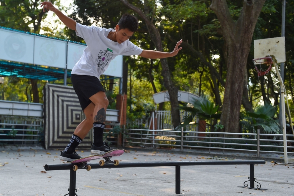 In this photo taken on Nov. 25, 2019, Tran Dinh Anh (C) practices skateboarding in front of Lenin statue at Lenin Park in Hanoi. They have few places to practice, no public funding and little public support, but Vietnam's first professional skateboard team are carrying high hopes of winning big at the upcoming SEA Games. — AFP