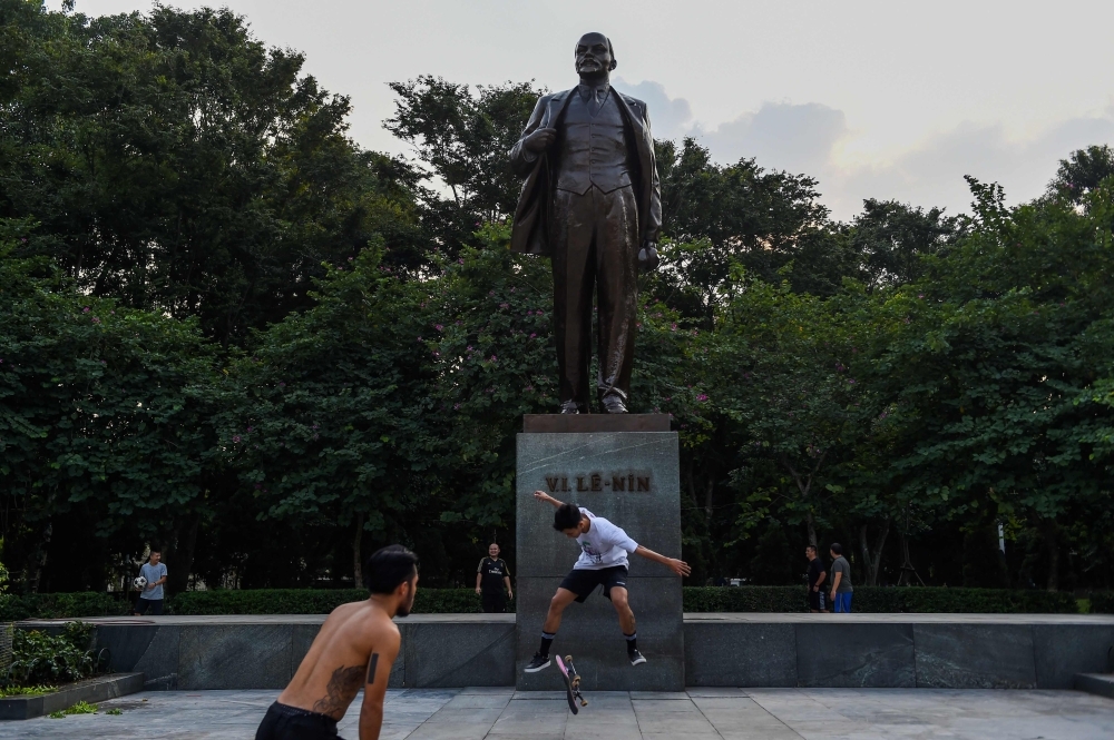In this photo taken on Nov. 25, 2019, Tran Dinh Anh (C) practices skateboarding in front of Lenin statue at Lenin Park in Hanoi. They have few places to practice, no public funding and little public support, but Vietnam's first professional skateboard team are carrying high hopes of winning big at the upcoming SEA Games. — AFP