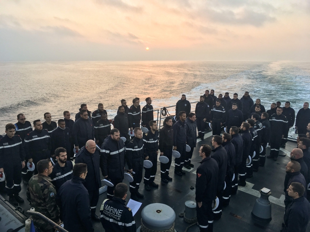 French sailors stand during a minute of silence on board Marine Nationale ship Commandant Birot (Aviso Type — Classe d'Estienne d'Orves) at an undisclosed location in The Black Sea, early Thursday. — AFP