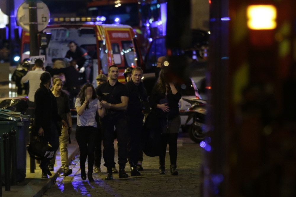 People are evacuated following an attack at the Bataclan concert venue in Paris in this Nov. 13, 2015 file photo. — AFP