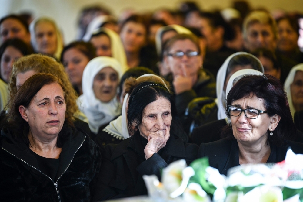 Relatives mourn over the coffins of six members of the Cara family who died during the earthquake in Thumane, Albania, on Friday. — AFP