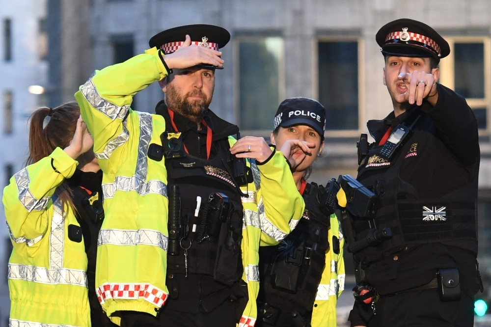 An armed police officer covers a cordon near London Bridge in London on Friday. — AFP