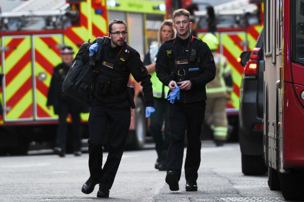 An armed police officer covers a cordon near London Bridge in London on Friday. — AFP