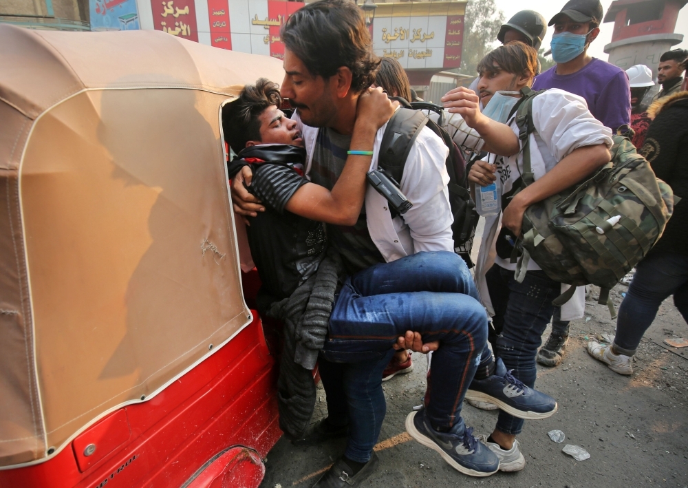 Iraqi demonstrators clash with security forces in Karbala on Friday. -AFP