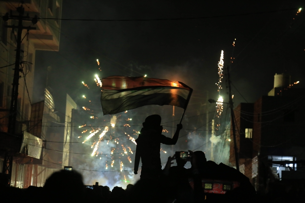 Iraqi demonstrators clash with security forces in Karbala on Friday. -AFP