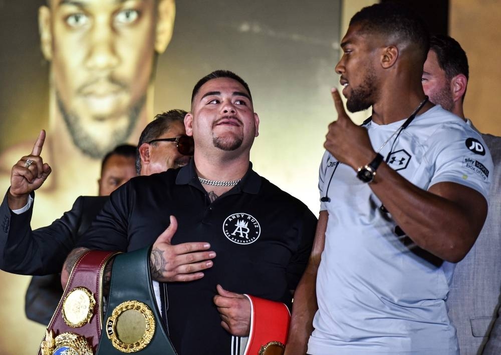 Mexican-American heavyweight boxing champion Andy Ruiz Jr (L) and British boxing challenger Anthony Joshua (R) pose together during a press conference ahead of the upcoming 